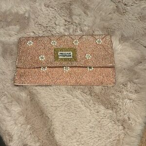 Press for Champagne clutch